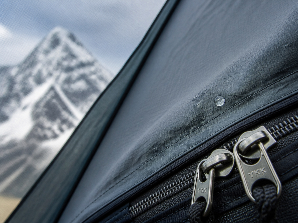 Close-up of water seeping through a seam on a 4-season tent's rainfly.